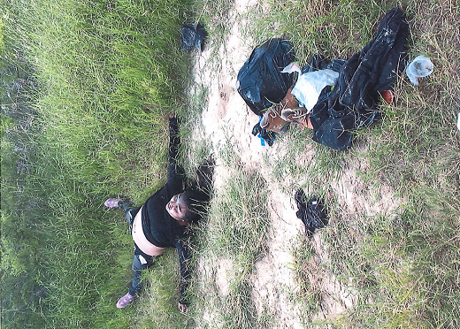 Brooks County Deputy Elias Pompa recovers the body of a deceased female migrant on a ranch in South Texas. (Photo: Brooks County Sheriff's Office/Deputy Elias Pompa)