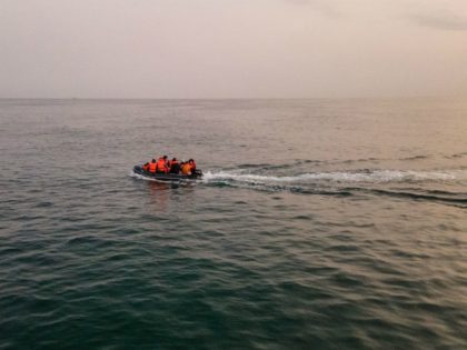 An aerial photo shows migrants in a dinghy wearing life jackets as they illegally cross th