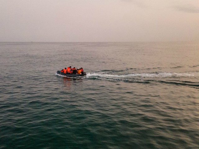 An aerial photo shows migrants in a dinghy wearing life jackets as they illegally cross the English Channel from France to Britain on September 11, 2020. - The number of migrants crossing the English Channel -- which is 33,8 km (21 miles) at the closest point in the Straits of …