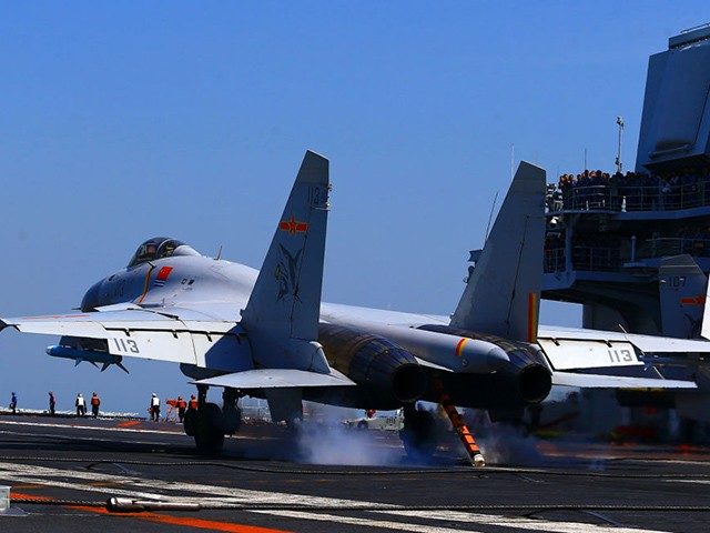 This photo taken on April 24, 2018 shows a J15 fighter jet landing on China's sole operational aircraft carrier, the Liaoning, during a drill at sea. - A flotilla of Chinese naval vessels held a "live combat drill" in the East China Sea, state media reported early April 23, 2018, …