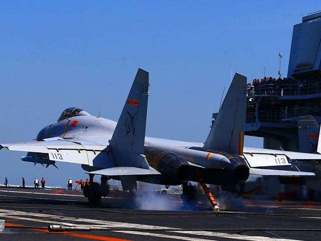 This photo taken on April 24, 2018 shows a J15 fighter jet landing on China's only operational aircraft carrier, the Liaoning, during an exercise at sea.  - A fleet of Chinese naval ships held a "Live combat training" In the East China Sea, state media reported as early as April 23, 2018, that this is the latest show of force by China's thriving navy in the disputed waters that has angered neighbors.  (Photo - /AFP) /China Championship (Photo should be as follows - /AFP via Getty Images)