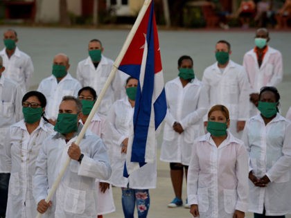 Doctors and nurses of Cuba's Henry Reeve International Medical Brigade take part in a farewell ceremony before traveling to Andorra to help in the fight against the coronavirus COVID-19 pandemic, at the Central Unit of Medical Cooperation in Havana, on March 28, 2020. (Photo by YAMIL LAGE / AFP) (Photo …