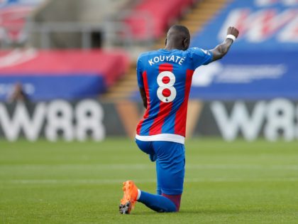 Crystal Palace's Cheikhou Kouyate takes a knee prior to the English Premier League soccer match between Crystal Palace and Southampton, at Selhurst Park, London, Saturday, Sept. 12, 2020. (AP Photo/Alastair Grant)