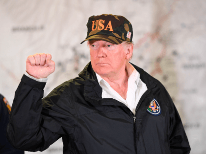 US President Donald Trump gestures while visiting fire fighters at Command Center Chico after viewing damage from wildfires in Chico, California on November 17, 2018. - President Donald Trump arrived in California to meet with officials, victims and the "unbelievably brave" firefighters there, as more than 1,000 people remain listed …