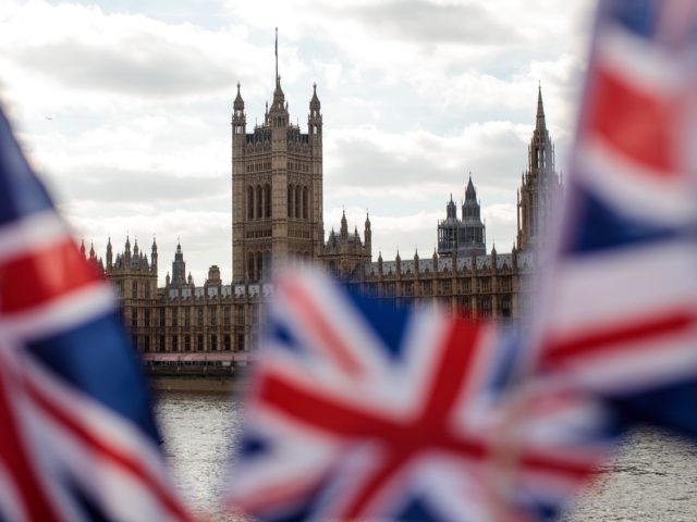 LONDON, ENGLAND - MARCH 26: Union Jack flags flutter in the wind in front of the Houses of Parliament in Westminster on March 26, 2019 in London, England. British Prime Minister Theresa May is facing increased pressure to resign as she continues her attempts to pass a Brexit deal through …
