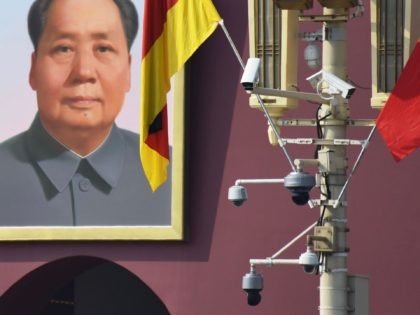 The German flag hangs next to surveillance cameras and the portrait of late communist leader Mao Zedong in Tiananmen Square in Beijing on September 6, 2019. German Chancellor Angela Merkel is currently visiting Beijing. - Some Beijing karaoke bars are closing, toy bombs are banned and every delivery package is …