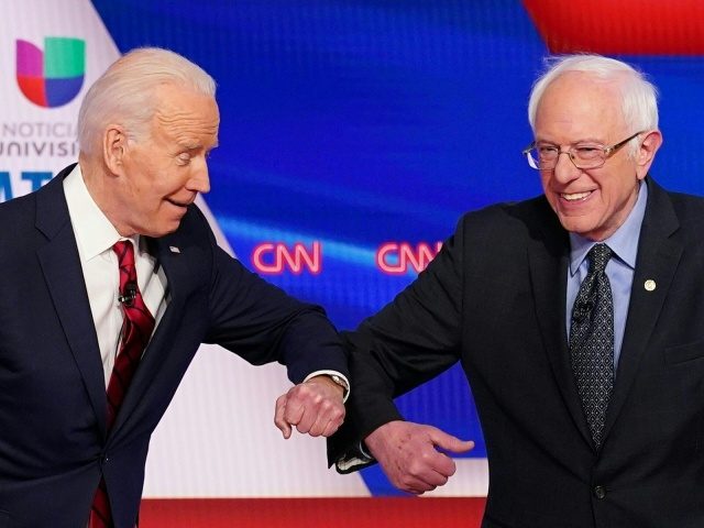 TOPSHOT - Democratic presidential hopefuls former US vice president Joe Biden (L) and Senator Bernie Sanders greet each other with a safe elbow bump before the start of the 11th Democratic Party 2020 presidential debate in a CNN Washington Bureau studio in Washington, DC on March 15, 2020. (Photo by …
