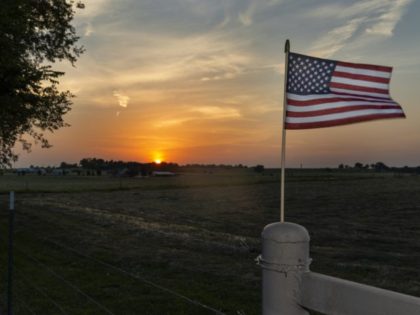 An American flag on the fence of a farm near the city of Commerce in the State of Oklahoma