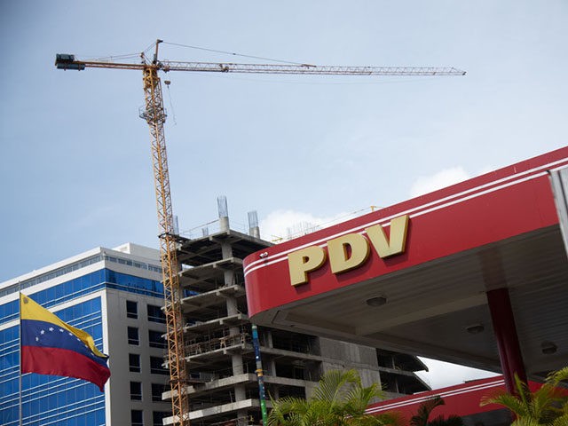 CARACAS, VENEZUELA - JUNE 01: View of PDVSA logo and the Venezuelan flag at a gas station in Las Mercedes on June 1, 2020 in Caracas, Venezuela. After 77 days, Maduro Administration eases the restrictions against COVID-19, allowing certain activities to reopen. From today, an official limit has been set …