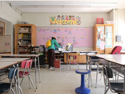 NEW YORK, NEW YORK - MAY 14: A teacher collects supplies needed to continue remote teaching through the end of the school year at Yung Wing School P.S. 124 on May 14, 2020 in New York City. In April, it was announced that NYC public schools would be closed at …