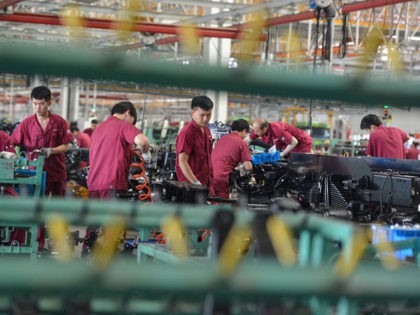 Employees work on a truck assembly line at a factory in Fuyang in China's eastern Anhui province on July 16, 2020. - China's economy returned to growth in the second quarter, rebounding more strongly than expected from a historic contraction caused by the coronavirus outbreak, official data showed on July …