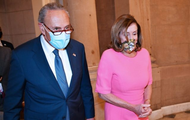 House Speaker Nancy Pelosi, D-CA, (R) and US Senate Minority Leader Chuck Schumer, D-NY, make their way to speak to the media, after meeting with the White House Chief of Staff and the US Treasury Secretary on coronavirus relief at the US Capitol in Washington, DC on August 7, 2020. …