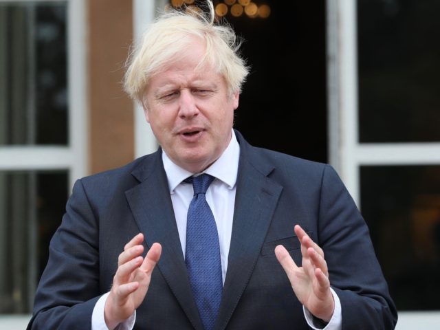 Prime Minister Boris Johnson poses on the steps of Hillsborough Castle on his arrival in B