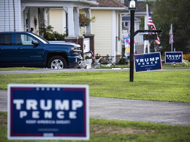 "Trump-Pence" signs and banners are seen on a street in Olyphant, just outside Scranton, Pennsylvania, on August 11, 2020. - It is not hard to miss the border between the industrial, mostly Democratic city of Scranton, Pennsylvania -- Joe Biden's hometown -- and its decidedly more right-leaning outskirts: amid all …
