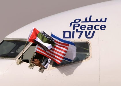 TOPSHOT - The Emirati, Israeli and US flags are picture attached to an air-plane of Israel's El Al, adorned with the word "peace" in Arabic, English and Hebrew, upon it's arrival at the Abu Dhabi airport in the first-ever commercial flight from Israel to the UAE, on August 31, 2020. …