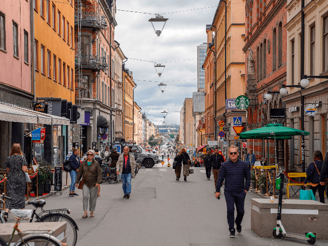 This picture taken in Stockholm, Sweden, on August 31, 2020, shows people walking in a street in Stockholm, amid the novel coronavirus pandemic. - While most of the world has come to terms with covering their noses and mouths in crowded places as a measure to prevent the spread of …