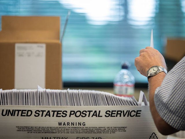 Absentee ballot election workers stuff ballot applications at the Mecklenburg County Board of Elections office in Charlotte, North Carolina on September 4, 2020. - The US election is officially open: North Carolina on September 4, 2020 launched vote-by-mail operations for the November 3 contest between President Donald Trump and Joe …