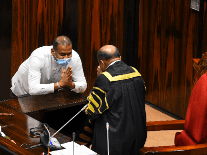Sri Lanka's convicted murderer Premalal Jayasekara (L) gestures after sworn in as a member