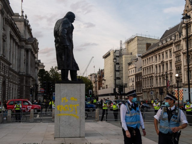 LONDON, ENGLAND - SEPTEMBER 10: The statue of Sir Winston Churchill is seen vandalised with spray paint as an Extinction Rebellion protest takes place in Parliament Square on September 10, 2020 in London, England. The Sir Winston Churchill statue was vandalised with the same message earlier in the year during …