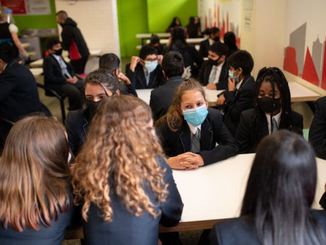 Year eight pupils wear face masks as a precaution against the transmission of the novel co