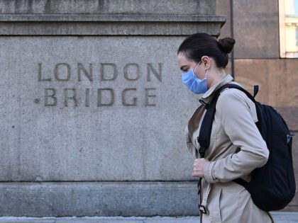 A commuter walks across London Bridge toward the City of London on September 15, 2020. - Britain's unemployment rate jumped above four percent in July on economic fallout from the coronavirus pandemic, official data showed today. (Photo by JUSTIN TALLIS / AFP) (Photo by JUSTIN TALLIS/AFP via Getty Images)