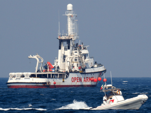 A patrol boat of the Italian Coast Guards (Guardia Costiera) sails past the rescue vessel of Spanish NGO Open Arms on September 17, 2020 off the port of Palermo, Sicily, after another patrol boat of the Guardia Costiera rescued a group of 76 migrants who threw themselves into the sea …