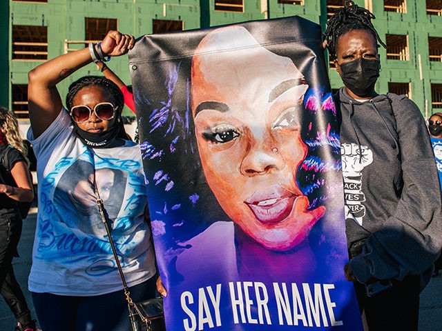 LOUISA, KY - SEPTEMBER 18: Two women hold a sign of Breonna Taylor during a rally on September 18, 2020 in Louisville, Kentucky. Protestors rallied in front of the Office Of The Attorney General headquarters to speak in preparation for a decision to be made regarding the officers involved in …