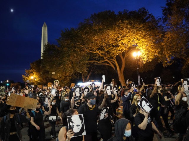 WASHINGTON, DC - SEPTEMBER 23: Demonstrators march near the White House in protest following a Kentucky grand jury decision in the Breonna Taylor case on September 23, 2020 in Washington, DC. A Kentucky grand jury indicted one police officer involved in the shooting of Breonna Taylor with 3 counts of …