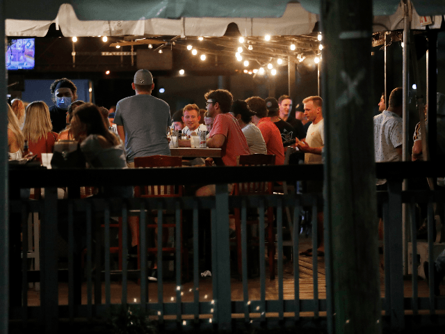 Patrons pack a bar to have drinks on the first day of full capacity seating is allowed on September 25, 2020 in Tampa, Florida. Florida Governor Ron DeSantis allows bars and restaurants to enter Phase 3 amid the coronavirus pandemic. (Photo by Octavio Jones/Getty Images)