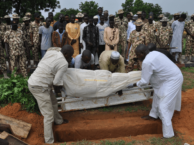 Nigerian soldiers and relatives look on as the body of a victim of the attack on vehicles carrying Borno governor Babagana Umara Zulum near the town of Baga on the shores of Lake Chad is buried during a the funeral in Maiduguri on September 26, 2020. - The insurgents opened …