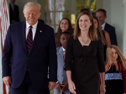 US President Donald Trump and Judge Amy Coney Barrett walk to the Rose Garden of the White