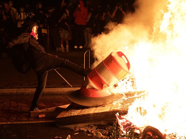 WASHINGTON, DC - MAY 31: Demonstrators set a fire during a protest near the White House on