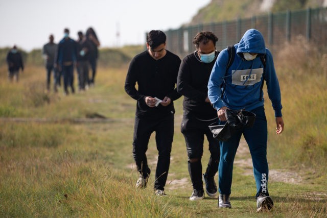 DEAL, ENGLAND - SEPTEMBER 15: Recently landed migrants walk along the coast on September 1