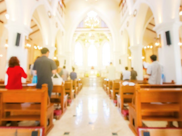 blurred christian mass praying inside the church