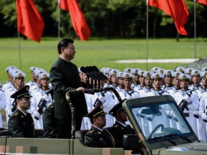 Tanks, missile launchers and chanting troops greeted President Xi Jinping in a potent display of Chinese military might on June 30 as part of his landmark visit to politically divided Hong Kong. / AFP PHOTO / Anthony WALLACE (Photo credit should read ANTHONY WALLACE/AFP via Getty Images)