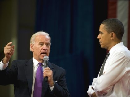 US President Barack Obama (R) and Vice President Joe Biden (L) speak during a town hall me
