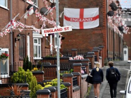 OLDHAM, ENGLAND - JUNE 15: School children walk along Wales Street in Oldham which local residents have re-named England Street and decorated with flags to celebrate the FIFA World Cup Russia 2018 on June 15, 2018 in Oldham, England. England play their first group match against Tunisia on Sunday (Photo …