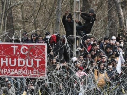 This picture taken from the Greek side of the Greece-Turkey border near Kastanies, shows migrants waiting on the Turkish side on March 2, 2020. - Greece was on a state of alert on March 1, 2020 as it faced an influx of thousands of migrants seeking to cross the border …