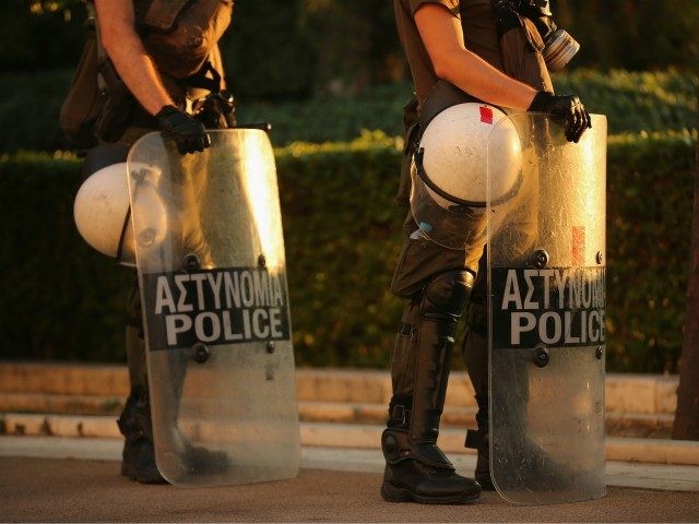 ATHENS, GREECE - JULY 13: Riot police stand by as protesters gather outside the Greek parliament to demonstrate against austerity after an agreement for a third bailout with eurozone leaders on July 13, 2015 in Athens, Greece. The bailout is conditional on Greece passing agreed reforms in parliament by Wednesday …