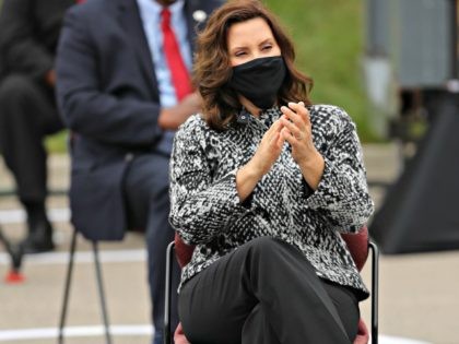 WARREN, MICHIGAN - SEPTEMBER 09: Wearing a face mask to reduce the risk posed by coronavirus, Michigan Governor Gretchen Whitmer applauds for Democratic presidential nominee and former Vice President Joe Biden as he addresses union leaders in the parking lot outside the United Auto Workers Region 1 offices on September …