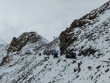 TOPSHOT - Indian Army vehicles drive on a road near Chang La high mountain pass in northern India's Ladakh region of Jammu and Kashmir state near the border with China on June 17, 2020. - India and China held top level talks on June 17 to "cool down the situation", …
