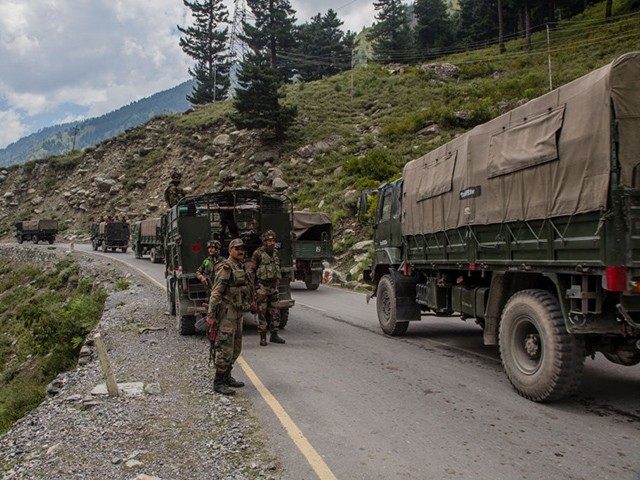 GAGANGIR, KASHMIR, INDIA - SEPTEMBER 2: Indian army convoy carrying reinforcements and supplies, drive towards Leh, on a highway bordering China, on September 2, 2020 in Gagangir, India. India and China, have stumbled once again into a bloody clash over their shared border. India rushed additional troops to Ladakh after claiming to have foiled what it called China's provocative maneuvers to change the status of Line of Actual Control, the de-facto border between the two countries, in the Himalayan region. As many as 20 Indian soldiers were killed in a "violent face-off" with Chinese troops in June this year in the Galwan Valley along the Himalayas. Chinese and Indian troops attacked each other with batons and rocks. The deadliest clash since the 1962 India-China war and both have not exchanged gunfire at the border since 1967. Since the recent clash, there has been no sign of a breakthrough. India said its soldiers were killed by Chinese troops when top commanders had agreed to defuse tensions on the Line of Actual Control, the disputed border between the two nuclear-armed neighbours. China rejected the allegations, blaming Indian soldiers for provoking the conflict, which took place at the freezing height of 14,000 feet. The killing of soldiers has led to a call for boycott of Chinese goods in India. (Photo by Yawar Nazir/Getty Images)
