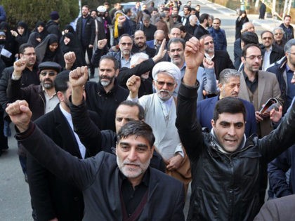 Supporters of the Basij, a militia loyal to the Islamic republic's establishment, chant anti-US slogans during a memorial for the victims of the Ukraine plane crash in University of Tehran on January 14, 2020. - Iran announced its first arrests over the shooting down of a Ukrainian airliner last week, …