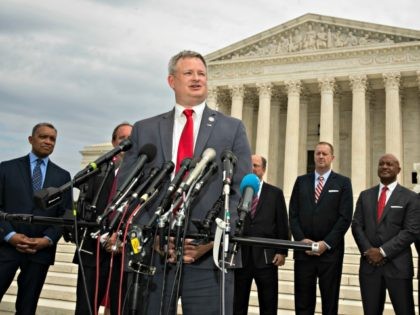 South Dakota Attorney General Jason Ravnsborg with a bipartisan group of state attorneys general speaks to reporters in front of the U.S. Supreme Court in Washington, Monday, Sept. 9, 2019. A bipartisan coalition of 48 states along with Puerto Rico and the District of Columbia said Monday it is investigating …