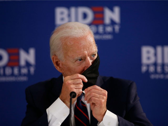 Democratic presidential candidate, former Vice President Joe Biden adjusts his mask during a roundtable on economic reopening with community members, Thursday, June 11, 2020, in Philadelphia. (AP Photo/Matt Slocum)