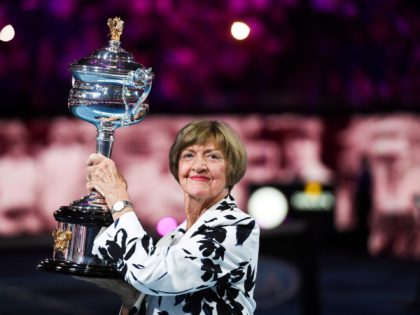 Former Australian tennis player Margaret Court poses with a replica of the trophy to commemorate 50 years of her Australian grand slam win before the start of men's singles match between Spain's Rafael Nadal and Australia's Nick Kyrgios on day eight of the Australian Open tennis tournament in Melbourne on …