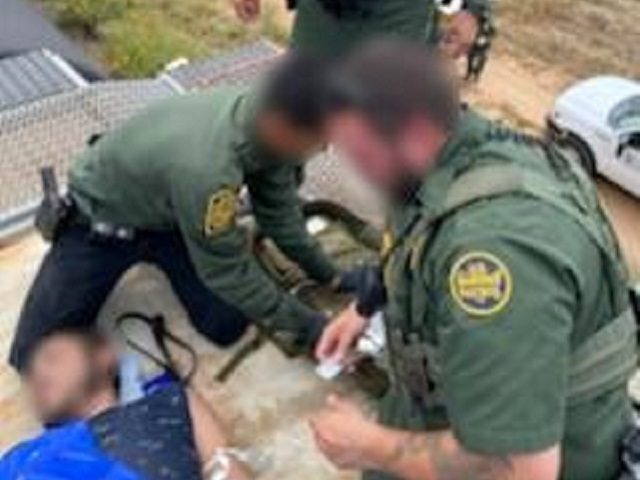 Laredo Sector Border Patrol agents provide emergency medical care for a COVID-19 infected illegal alien found in a grain hopper rail car. (Photo: U.S. Border Patrol/Laredo Sector)