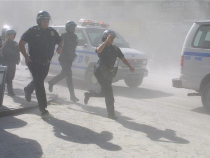Police officers rush to help after terrorists crashed two planes into the World Trade Center on Tuesday, September 11, 2001. In a horrific sequence of destruction, terrorists hijacked two airliners and crashed them into the World Trade Center in a coordinated series of attacks that brought down the twin 110-story …