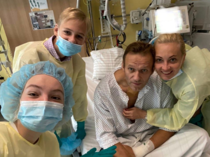 Navalny appears in the hospital photo with his wife Yulia and two children.