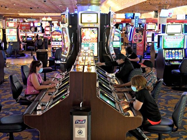 LAS VEGAS, NEVADA - JUNE 18: Guests play slot machines at the Westgate Las Vegas Resort & Casino after the property opened for the first time since being closed in mid-March because of the coronavirus (COVID-19) pandemic on June 18, 2020 in Las Vegas, Nevada. Hotel-casinos throughout the state were …